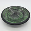 Small mosaic tile dish in green with concentric rings of glass tiles and a smooth black rim