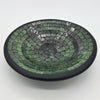 Small mosaic tile dish in green with concentric rings of glass tiles and a smooth black rim