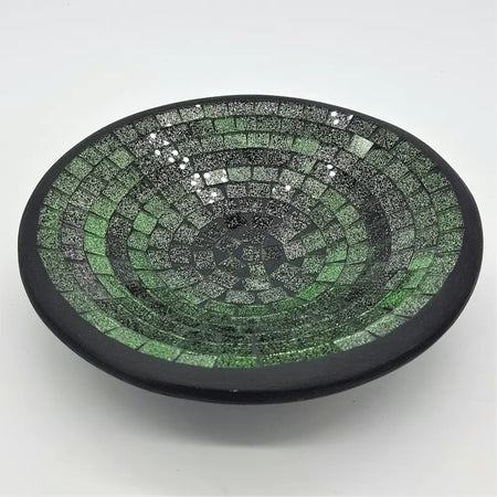 Small mosaic tile dish in green with concentric rings of glass tiles and a smooth black rim