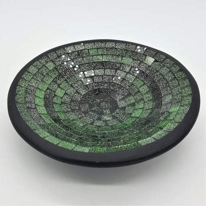 Small mosaic tile dish in green with concentric rings of glass tiles and a smooth black rim