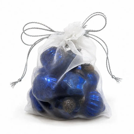 A clear organza bag with silver drawstring filled with shiny blue mouth-blown glass baubles small set of 12