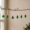 A set of five green mouth-blown glass baubles shaped as heart star sphere acorn and teardrop ornaments