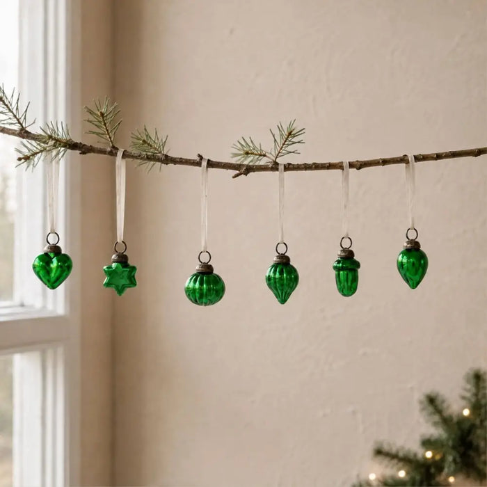A set of five green mouth-blown glass baubles shaped as heart star sphere acorn and teardrop ornaments