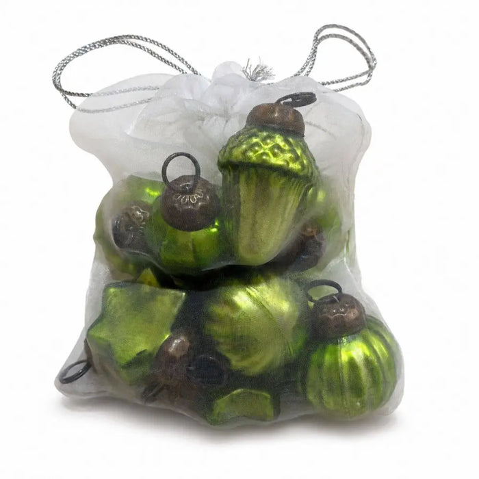 A bag of 12 lime green mouth-blown glass baubles shaped like acorns and leaves with dark brown caps in a white bag