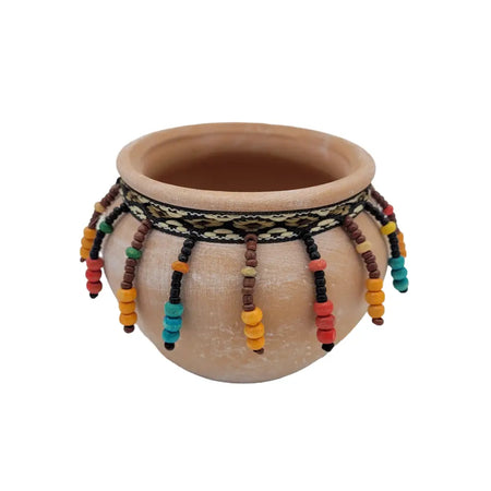 Small natural terracotta plant pot with black and cream band and colorful orange red teal brown yellow beaded tassels