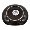 Small oval ceramic plate in black with a glossy finish and subtle textured ridges along its sides