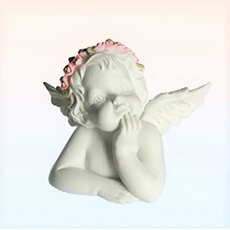Small resting angel ornament in white with a smooth matte finish and a delicate pink floral crown resting on one elbow