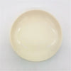 Small round ceramic plate in cream color with glossy finish and raised rim suitable for serving food