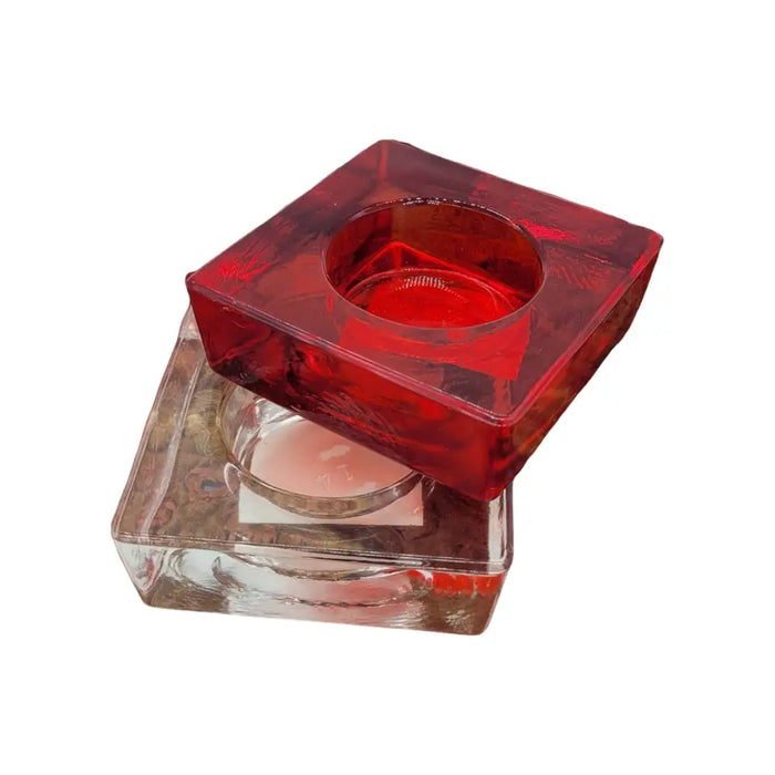 Small square glass tealight holder in vibrant red with textured translucent surface and circular indentation for tealight