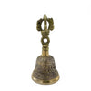 A small brass tingsha bell with intricate engraved designs and a decorative handle for Tibetan rituals