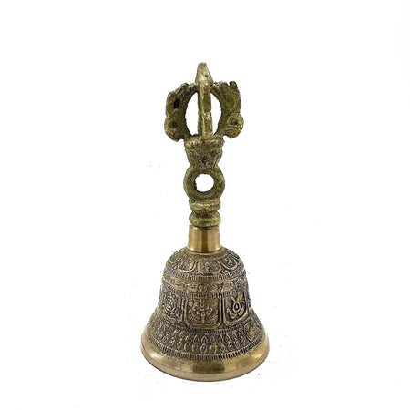 A small brass tingsha bell with intricate engraved designs and a decorative handle for Tibetan rituals