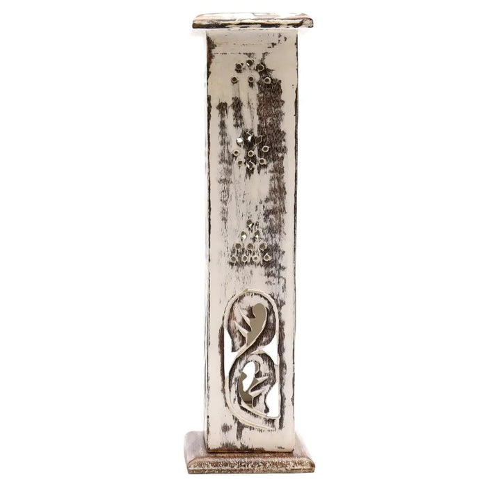 A tall distressed whitewashed wooden smoke tower candle holder with intricate cutout designs and metal accents