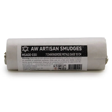 A white cylindrical smudge stick roll with seven chakras rose petals sage and a black label detailing contents