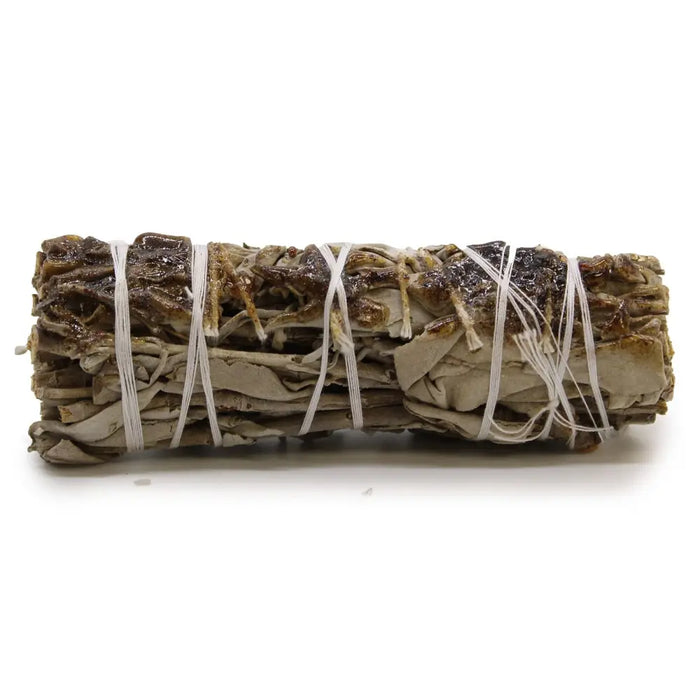 A smudge stick of dried copal sage tied with white twine showing beige and dark brown hues measuring 10cm