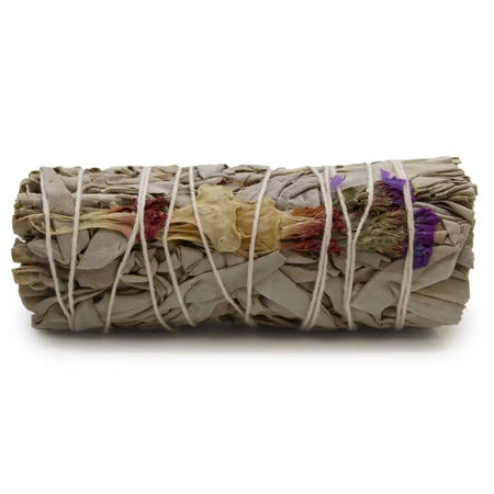 A rolled good vibes sage smudge stick tied with twine featuring gray leaves and dried purple red and yellow flowers