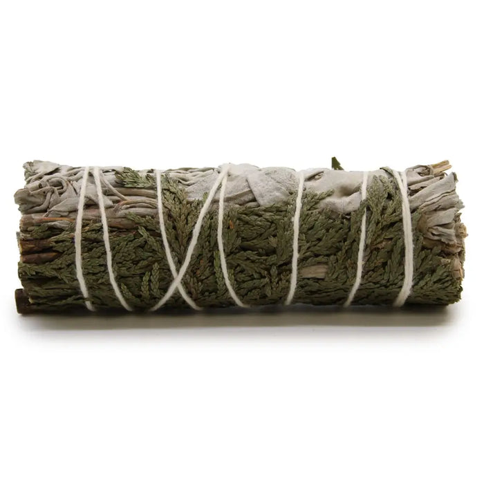 A tightly bound smudge stick of white sage and cedar tied with white twine known for purifying properties and clearing negative energy