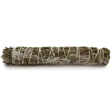A smudge stick of white sage and cedar tied with white twine used for spiritual cleansing measures 22cm long
