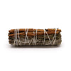A bundled smudge stick with white sage cedar and cinnamon sticks tied together with white string 10cm long