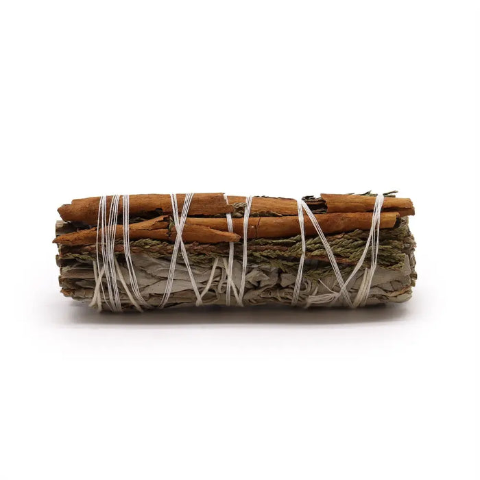 A bundled smudge stick with white sage cedar and cinnamon sticks tied together with white string 10cm long