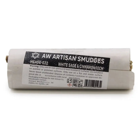A cylindrical smudge stick wrapped in off-white paper with black label featuring white sage and cinnamon scents
