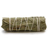 A smudge stick made of white sage and eucalyptus tied with white twine and measuring 10 cm in length