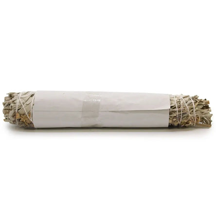 A bundle of dried white sage smudge stick tied with twine and wrapped in plain white paper band with lavender