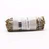 A bundled white sage smudge stick wrapped in a paper label with black text measuring about 10cm tall