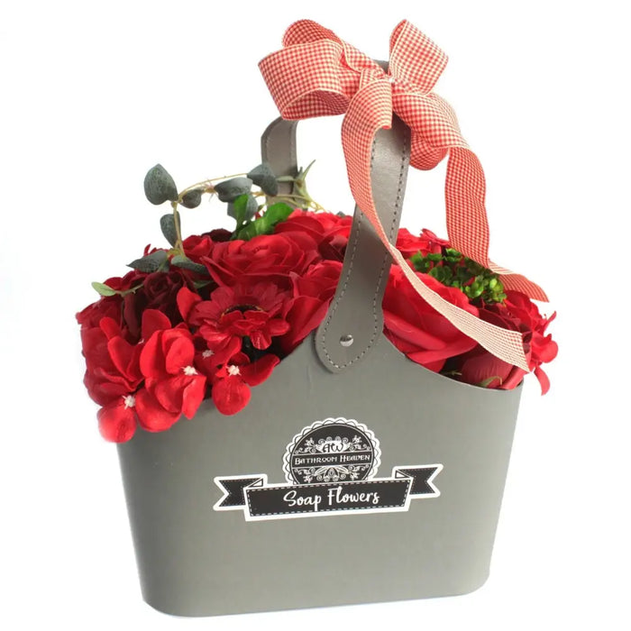 Gray metal soap flower basket with red artificial roses and a red and white gingham ribbon bow