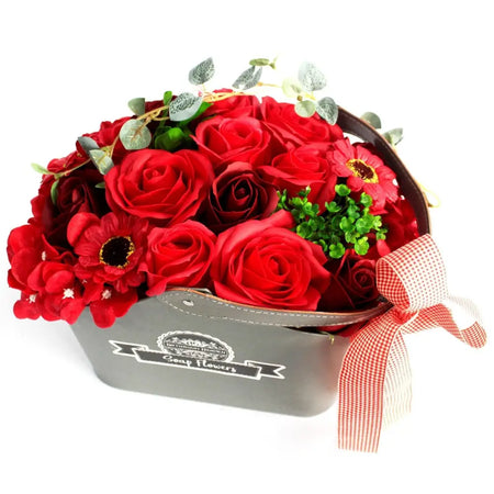 A soap flower basket with red soap roses and flowers in a gray metal box tied with a red-and-white checkered ribbon