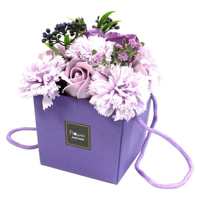Purple soap flowers arranged as a handcrafted bouquet of lavender rose and carnation in a lavender box with strap