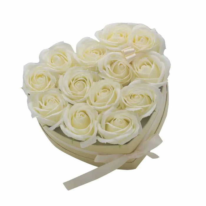 Heart shaped box of creamy white soap flowers tied with a matching satin ribbon in a rose heart bouquet design