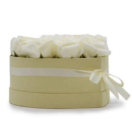 Elegant cream-colored box filled with white soap flowers shaped like roses tied with a cream satin ribbon