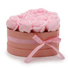 A heart-shaped box filled with soft pink soap flowers shaped like roses tied with a matching satin ribbon