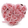 A heart-shaped box filled with pink soap flowers made of foam and tied with a matching satin ribbon