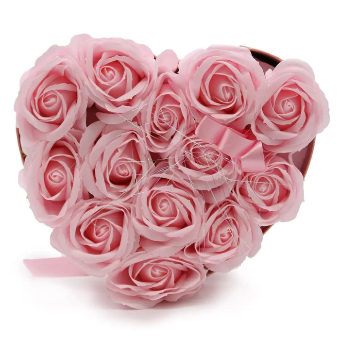 A heart-shaped box filled with pink soap flowers made of foam and tied with a matching satin ribbon