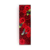 A soap flower gift box with vibrant red roses and dark red soap carnations accented by green leaves and purple flowers