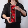 A soap flower gift box with red roses and dark purple berries arranged in a decorative pattern