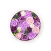 A circular flower gift box with purple pink and white soap flowers including lavender rose and carnation