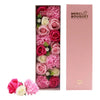 A pink and white soap flower gift box with roses and carnations made of soap called baby blessings