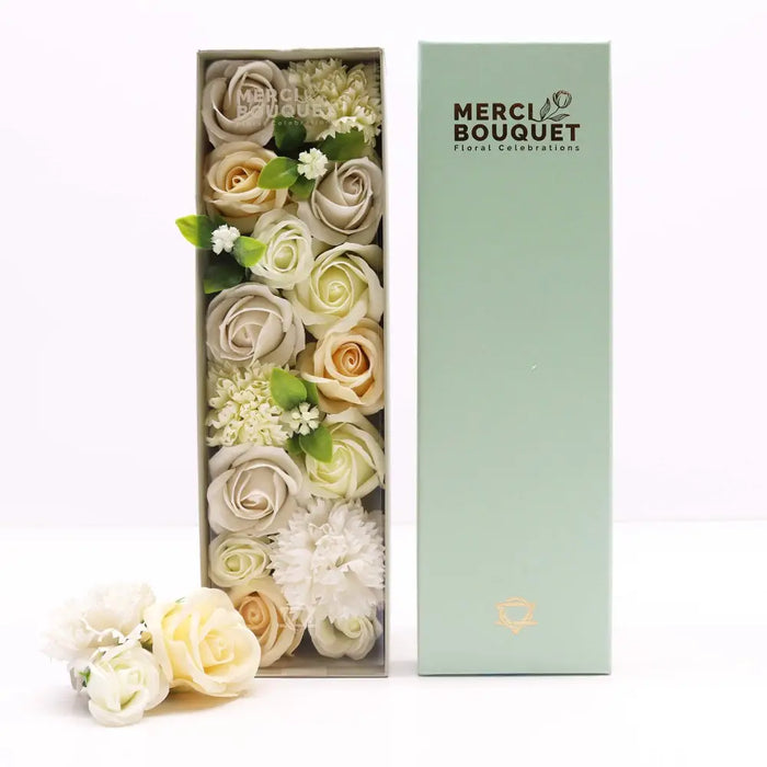 A soap flower gift box with cream ivory and pale yellow artificial roses in a mint green rectangular container for wedding blessings