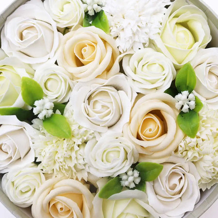 A soap flower gift box with white and ivory soap roses and green leaves for wedding blessings