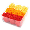 A set of nine peach rose bath soap flowers in red orange and yellow arranged in a clear plastic box