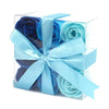 A set of blue soap flowers shaped like roses in a clear box tied with a light blue satin ribbon