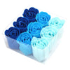 A set of nine blue soap flowers shaped like roses in shades from navy to sky blue in a clear plastic box