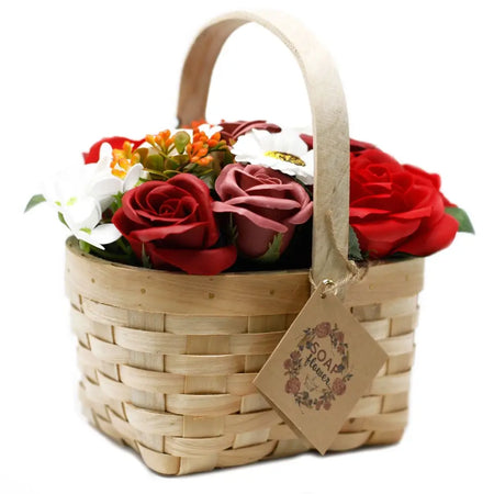 A woven wicker basket filled with red pink and white artificial soap flowers in a large arrangement