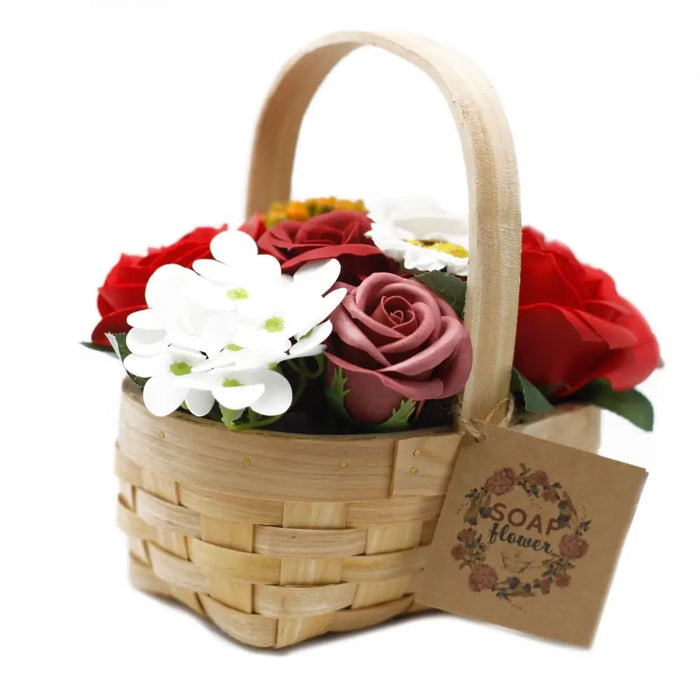 A woven wicker basket filled with red pink and white soap flowers in a medium natural wood basket