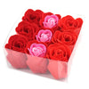 A set of nine red and pink artificial rose soap flowers arranged neatly inside a clear plastic box