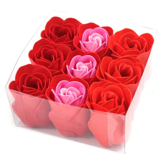 A set of nine red and pink artificial rose soap flowers arranged neatly inside a clear plastic box
