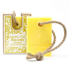 Bright yellow rectangular bar of agnes cat fresh citrus fragranced coconut butter soap with natural twine loop for hanging