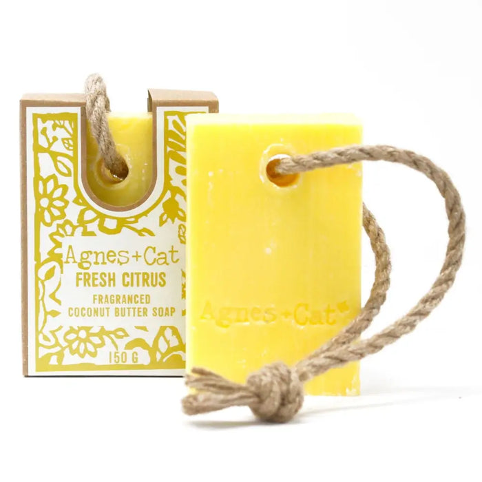 Bright yellow rectangular bar of agnes cat fresh citrus fragranced coconut butter soap with natural twine loop for hanging